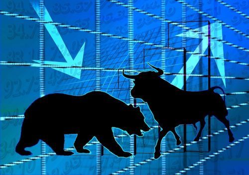Black silhouettes of a bear and a bull against a blue background with falling stock market prices and arrows