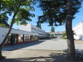 View of the schoolyard of the school at the community centre with the building in the background