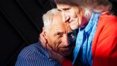 Elderly couple holding each other in their arms